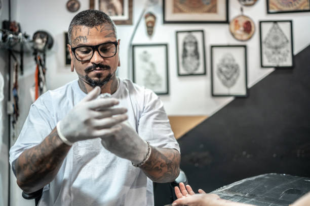 istock Tattoo artist preparing to tattoo a customer at a tattoo studio 1475637092