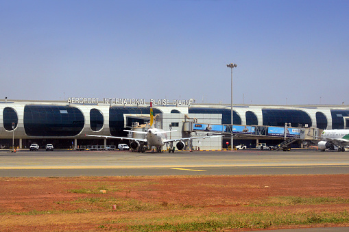 Dakar, Senegal: Blaise Diagne International Airport - Dakar international airport (AIBD, IATA DSS) - The main international airport of the Senegalese capital since 2017, when it replaced Dakar-Léopold Sédar Senghor Airport because it was no longer able to cope with rising passenger numbers and freight rates. The new airport is 45 kilometers south-east of Dakar, near Diass in the Thiès region. It serves as the home base and hub of national airline Air Senegal. View of the main terminal, air side, with passenger boarding bridges and aircraft.