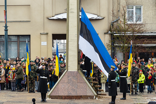 Tallinn, Estonia - March 11 2023: Flags of Estonia and Ukraine flags waving together during a flag raising in an official ceremony with soldiers