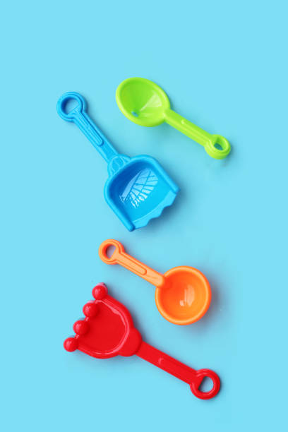 istock Plastic toys on blue background. Summer background concept 1475641578