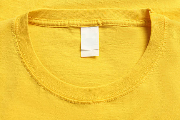 istock Blank clothing label on yellow T-shirt, top view 1475643208