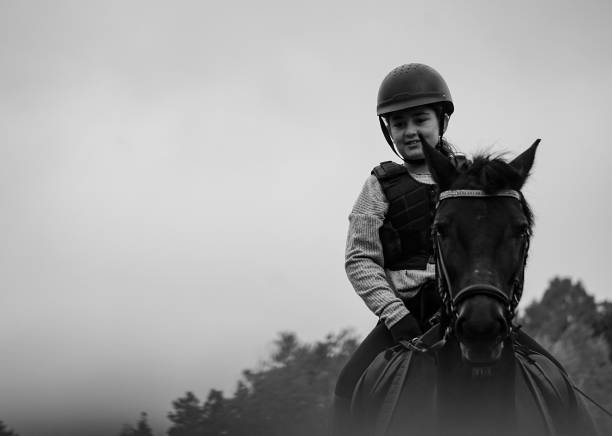 A girl riding a horse against sky