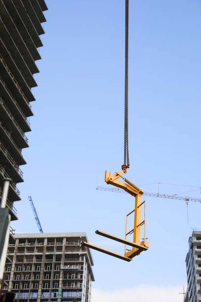 istock Tower crane near unfinished buildings against cloudy sky on construction site 1475644131