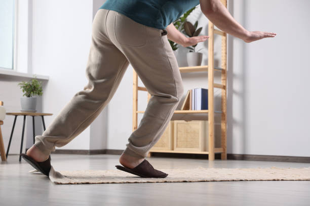 istock Man tripping over rug at home, closeup 1475644758