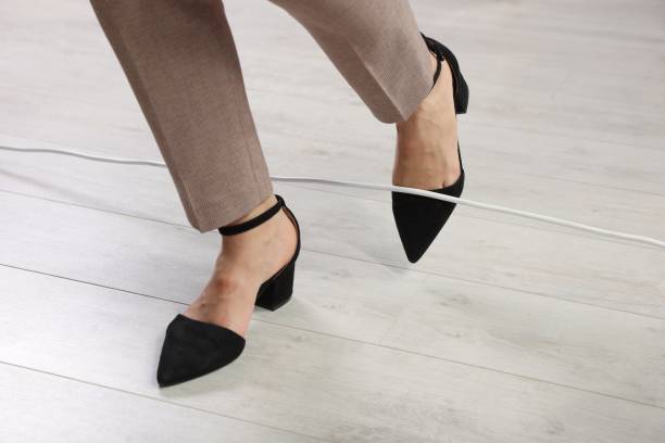 istock Woman tripping over cord indoors, closeup view 1475644892