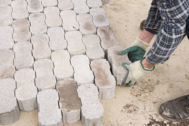 istock male worker puts brick blocks in the garden path 1475645304
