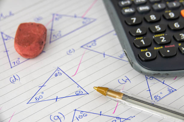 Math Homework Or Exam A Child's Math (Geometry) Homework Or Exam, With Calculator, Pen And Eraser homework stock pictures, royalty-free photos & images