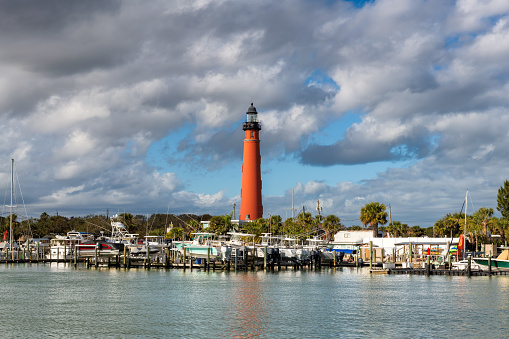 Beautiful Lighthouse Ponce Inlet in harbor at sunny day, Daytona Beach, Florida, USA.