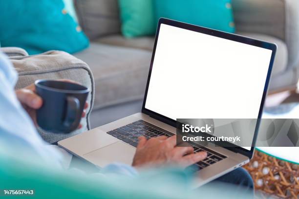 Mature Man Using A Blank Screen Laptop At Home Stock Photo - Download Image Now - Laptop, Computer, Template