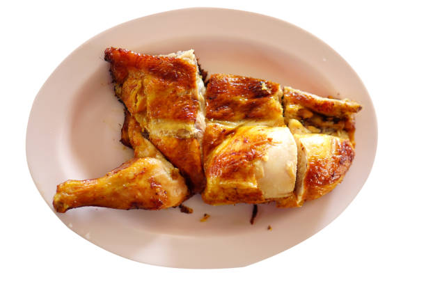 Whole roasted chicken is placed in a tray.