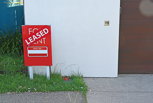 For rent sign with a leased sticker on it