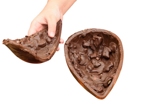 istock Child picking up half of dark chocolate Easter egg with crunchy almonds. 1475666352