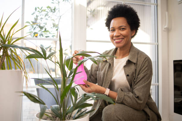 istock Woman enjoying with her plants at home 1475667855