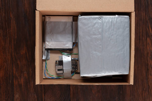 istock Hand made bomb with c4 and cell phone module in a cardboard box 1475668091