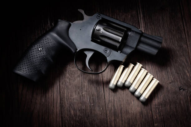 istock revolver handgun on wooden table 1475668218