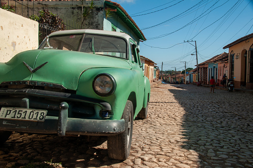 Trinidad, Cuba - December 21, 2017: An old green car on the cobble streets of Cuba