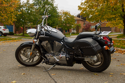 Antalya, Turkey - May 12, 2013: Harley Davidson is Americas greatest manufacturer of motor cycles. Black custom Harley davidson motorcycle photographed with Harley Davidson Store.Motorbike.