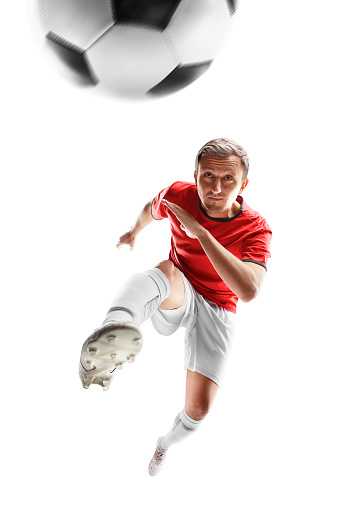 confident young multiethnic soccer players standing with balls and looking at camera isolated on white