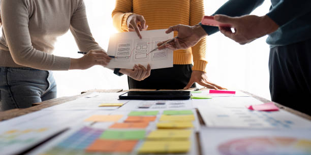 istock Close up view of brainstorm team of creative Web Graphic Designer ux developer and ui designer brainstorming about mobile app interface wireframe design 1475678012