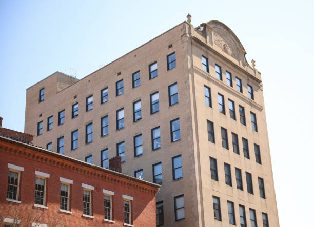 istock skyscraper's towering structure and old-fashioned architecture. multiple stories, with numerous rows of brickwork stacked upon each other to form its exterior walls. The bricks are weathered and worn 1475679255
