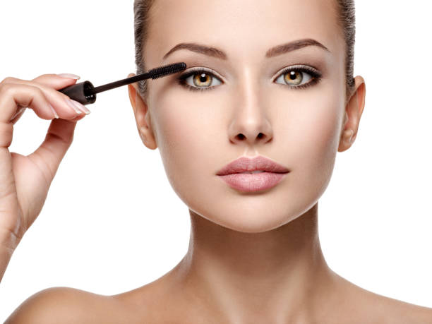 istock woman applying cosmetic mascara on eyelashes using curling brush 1475686627