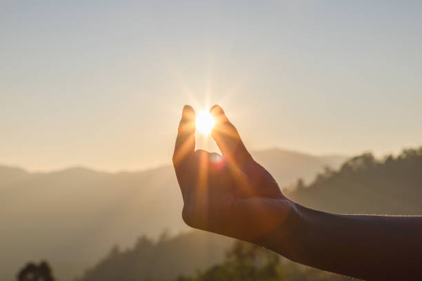 istock Silhouette catching the sun at sunset in fingers 1475690093
