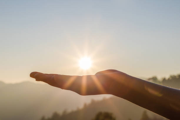 istock Silhouette hands holding the sun at dawn 1475690099