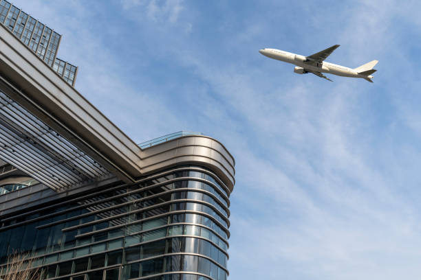 airplane fly over modern building exterior with copy space. stock photo