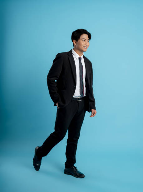 istock image of young businessman posing on a blue background 1475707886