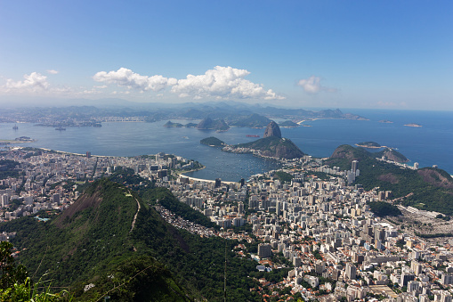 Aerial view of Rio de Janeiro, Brazil, featuring the beautiful Botafogo Bay and the iconic Sugarloaf Mountain. The photo offers a unique perspective of the city's natural beauty and topography.