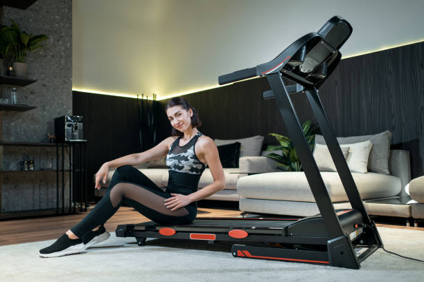 istock female athlete prepare for training with treadmill 1475720322