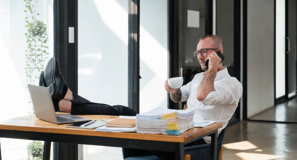 istock Happy business man with phone call while relaxing in the office 1475721696