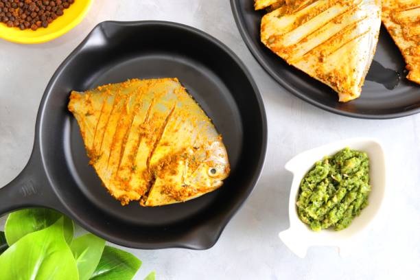 istock Fresh Marinated Pomfret fish or butter fish is cleaned and ready for frying along with spices. ingredients and recipe background with copy space 1475724672