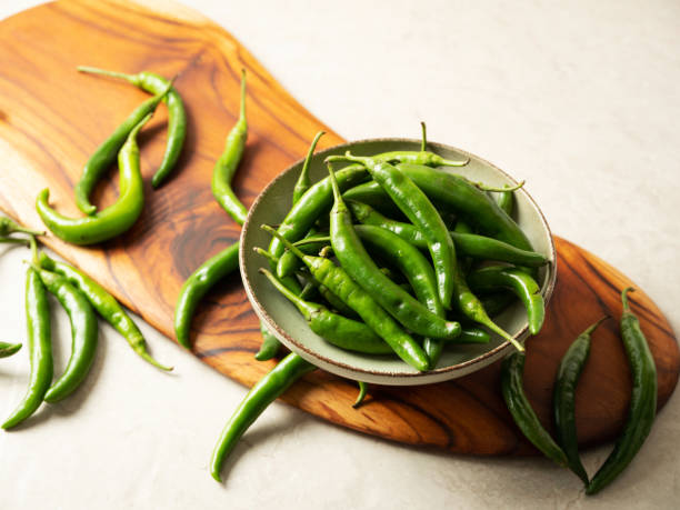 istock fresh green chillies on chopping board 1475725477