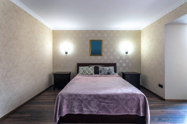 Hotel room with a large double bed in light colors.