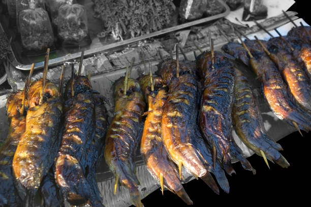 Die cut of grilled catfish on the banana leaf on black isolated.