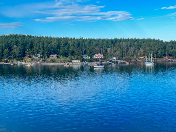 istock A small boat docked on the coastline with island on the backdrop and blue sky 1475730145