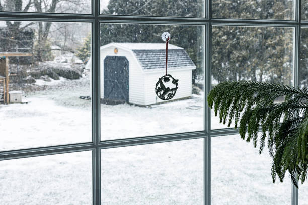 istock Hummingbird Trinket Hanging on Winter Back Yard Bay Window 1475730343
