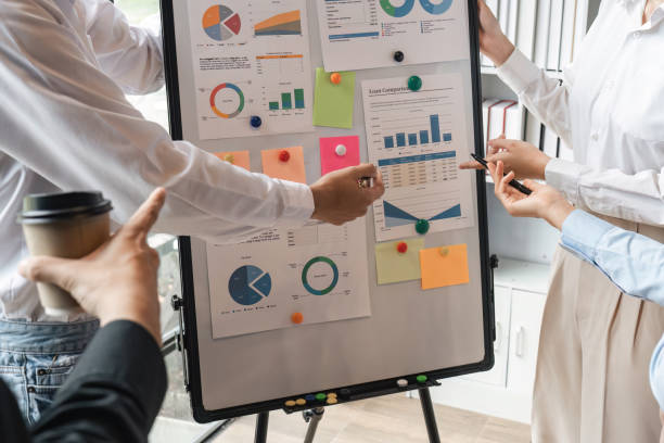 istock Team work process. Marketing strategy brainstorming on board. Paperwork and digital in modern office. 1475730394
