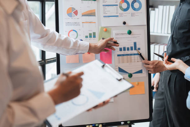 istock Team work process. Marketing strategy brainstorming on board. Paperwork and digital in modern office. 1475730409
