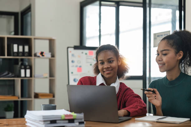 istock Young group of diverse students studying together using laptop at home. College multiracial people working on university group assignment homework project in modern apartment 1475731830