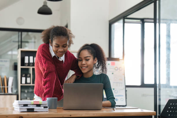 istock Young group of diverse students studying together using laptop at home. College multiracial people working on university group assignment homework project in modern apartment 1475731878