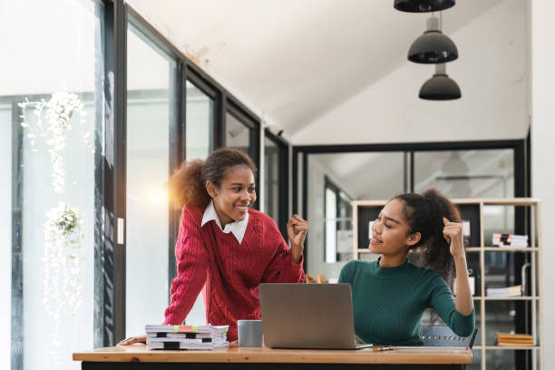 istock Young group of diverse students studying together using laptop at home. College multiracial people working on university group assignment homework project in modern apartment 1475731928