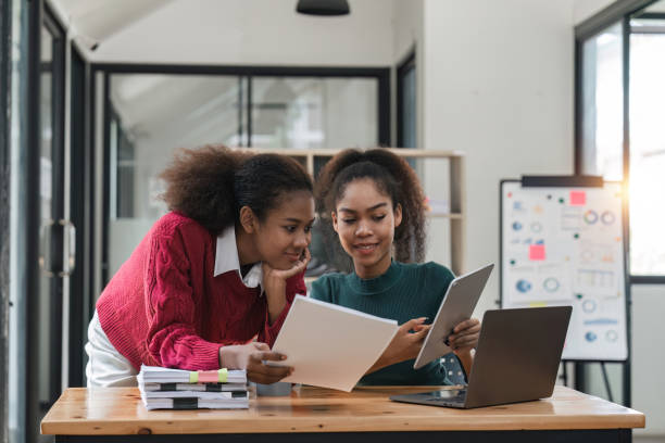 istock Young group of diverse students studying together using laptop at home. College multiracial people working on university group assignment homework project in modern apartment 1475731977