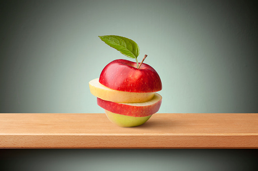 Apple with leaf on the shelf.