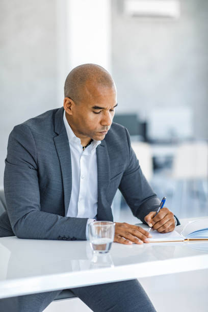 istock African American entrepreneur taking notes in the office. 1475741330