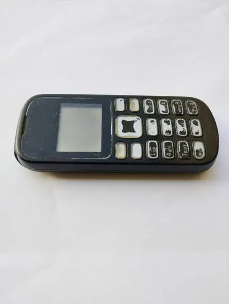 a close-up photo of a black mobile phone that was once in demand on the world market, and is now being abandoned by the public, they have switched to smartphones