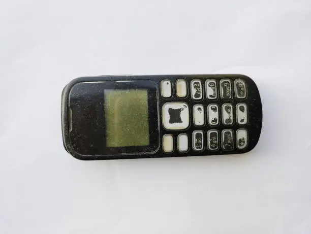 a close-up photo of a black mobile phone that was once in demand on the world market, and is now being abandoned by the public, they have switched to smartphones