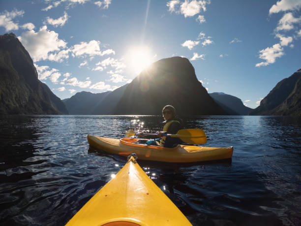 istock Kayaker on a lake with mountains 1475754513