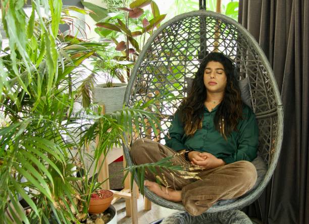 istock A young non-binary person meditating in his home 1475754991